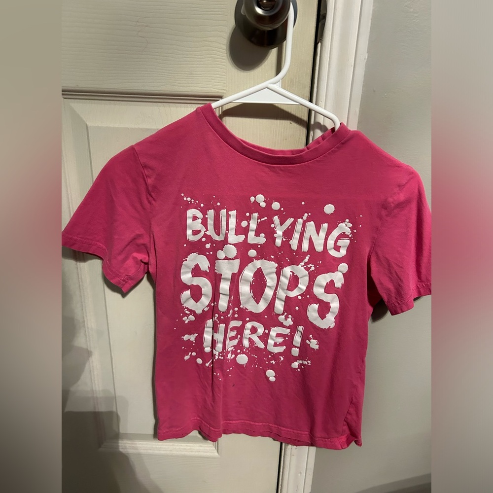 George “Bullying Stops Here” pink tee shirt. Children’s L (10-12) used. Stain.